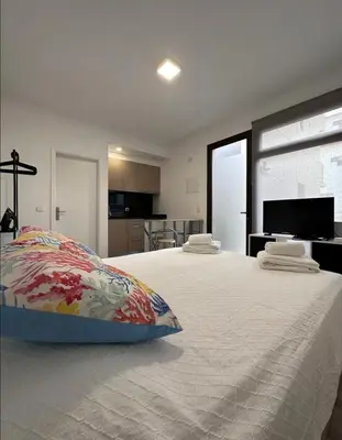 a bedroom with a large bed with a pillow on it at Valhalla Madeira Apartements in Funchal