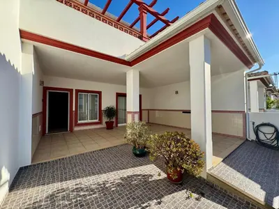 a home with a patio with potted plants at Burgau Serenity in Luz