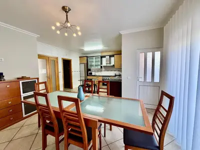 a kitchen and dining room with a table and chairs at Burgau Serenity in Luz