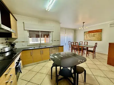 a kitchen with a table and a dining room at Burgau Serenity in Luz