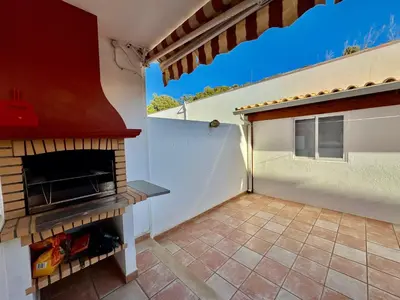 an outdoor patio with a fireplace and a staircase at Burgau Serenity in Luz