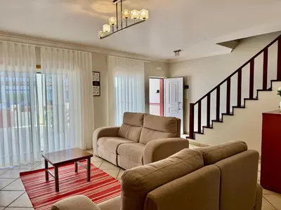 a living room with a couch and a table at Burgau Serenity in Luz