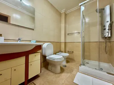 a bathroom with a toilet and a sink and a shower at Burgau Serenity in Luz