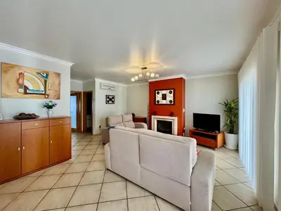 a living room with a couch and a tv at Burgau Serenity in Luz