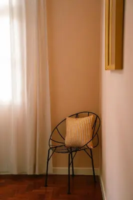 a chair sitting in a corner with a window at Casa d'Avo - 3BD cosy home in Funchal