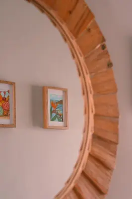 a mirror on a wall with two framed pictures at Casa d'Avo - 3BD cosy home in Funchal