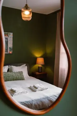 a reflection of a bed in a mirror at Casa d'Avo - 3BD cosy home in Funchal