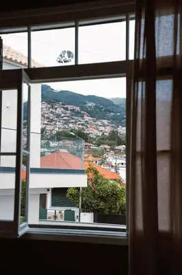 a view of a city from a window at Casa d'Avo - 3BD cosy home in Funchal