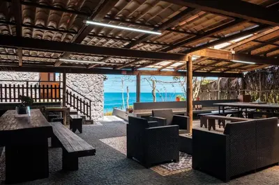 a restaurant with tables and chairs and a view of the ocean at GuestReady - Magical refuge in Madeira in Seixal