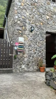 a stone building with a book shelf on it at GuestReady - Magical refuge in Madeira in Seixal