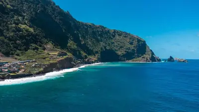 an aerial view of a beach next to a mountain at GuestReady - Magical refuge in Madeira in Seixal