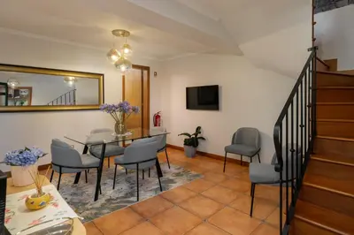 a dining room with a table and chairs at Casa Jardim Celeste in Seixal