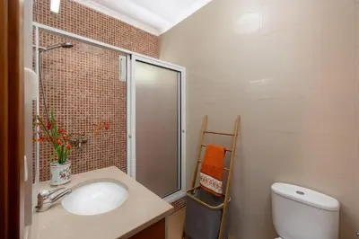a bathroom with a sink and a shower and a toilet at Casa Jardim Celeste in Seixal