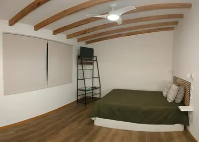a bedroom with a bed and a ceiling fan at Amendoeira House - House in Ponta do Sol in Ponta do Sol