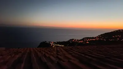 a view of the sun setting over the ocean at Amendoeira House - House in Ponta do Sol in Ponta do Sol