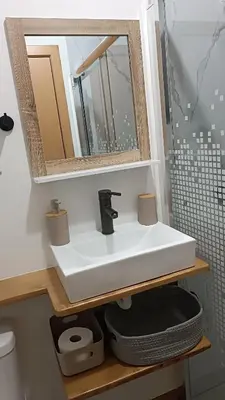 a bathroom with a white sink and a mirror at Amendoeira House - House in Ponta do Sol in Ponta do Sol