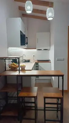a kitchen with a table with a bowl of food on it at Amendoeira House - House in Ponta do Sol in Ponta do Sol