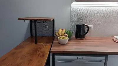 a wooden counter top with a bowl of fruit and a coffee maker at Amendoeira House - House in Ponta do Sol in Ponta do Sol
