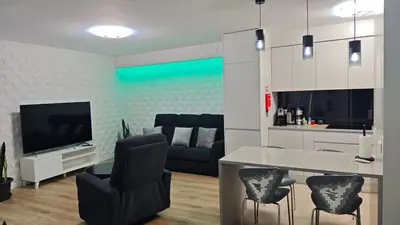 a living room with a couch and a table and chairs at Funchal Center Accomodation in Funchal