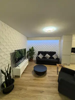 a living room with a couch and a tv at Funchal Center Accomodation in Funchal