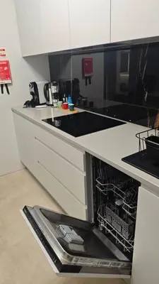 a kitchen with an open dishwasher in a counter at Funchal Center Accomodation in Funchal