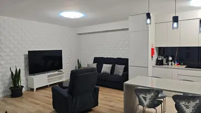 a living room with a couch and a television at Funchal Center Accomodation in Funchal