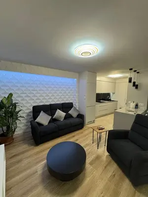 a living room with a couch and a table at Funchal Center Accomodation in Funchal