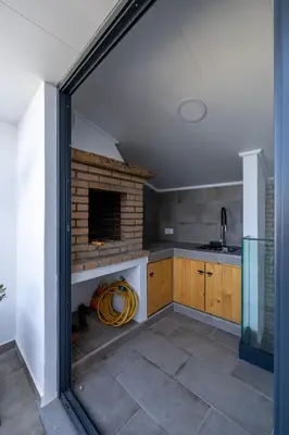 a kitchen with a brick fireplace in a room at No Stress House in Paul do Mar