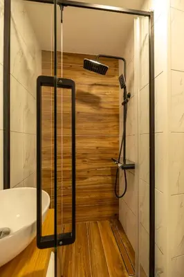 a bathroom with a shower with a tub and a sink at No Stress House in Paul do Mar