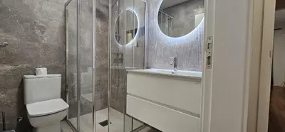 a bathroom with a toilet and a sink and mirror at Achada View by Rentallido in Funchal
