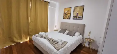 a bedroom with a large white bed in a room at Achada View by Rentallido in Funchal