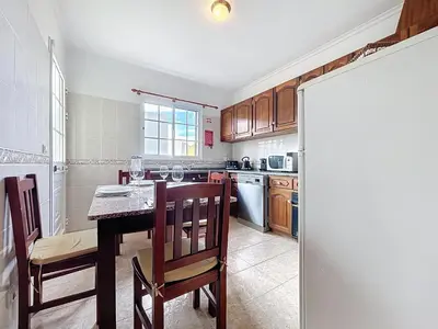a kitchen with a table and chairs and a counter top at Gaula Family Haven by Atlantic Holiday in Gaula
