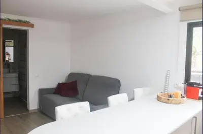 a living room with a couch and a table at Mocha House in Machico