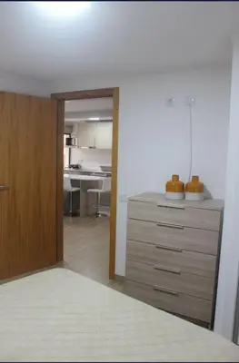 a room with a dresser with a kitchen in the background at Mocha House in Machico