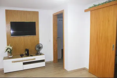 a living room with a television on a wall at Mocha House in Machico
