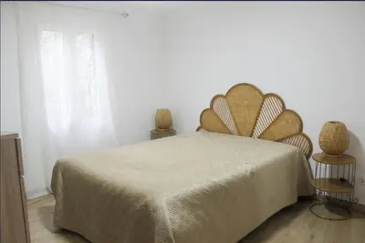 a bedroom with a large bed and two vases at Mocha House in Machico