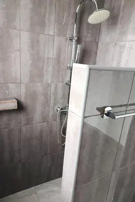 a shower with a glass door in a bathroom at A Casa do Encanto da Ana & Luis in Ponta do Sol