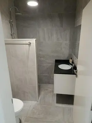 a bathroom with a white sink and a toilet at A Casa do Encanto da Ana & Luis in Ponta do Sol