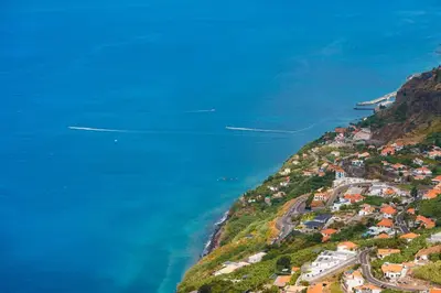 an aerial view of a town on a hill next to the ocean at GuestReady - Exquisite stay with sea views in Calheta