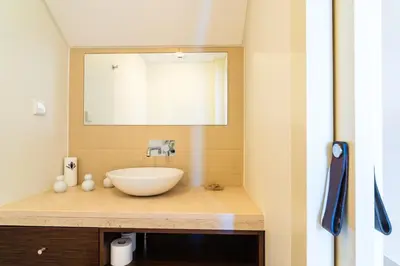 a bathroom with a bowl sink and a mirror at GuestReady - Exquisite stay with sea views in Calheta