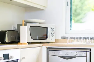 a microwave sitting on a kitchen counter next to a microwave oven at GuestReady - Exquisite stay with sea views in Calheta