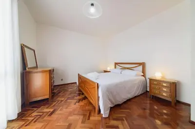 a bedroom with a bed and a dresser and a mirror at Casa do Massapez by Mth in Santa Cruz
