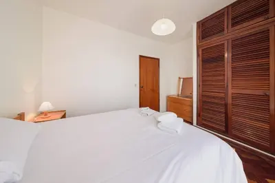 a bedroom with a large white bed with two towels on it at Casa do Massapez by Mth in Santa Cruz