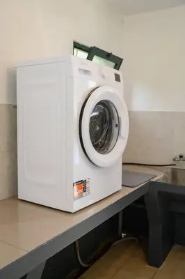 a washing machine sitting on top of a counter at Casa do Massapez by Mth in Santa Cruz