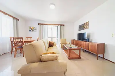 a living room with a couch and a tv at Casa do Massapez by Mth in Santa Cruz