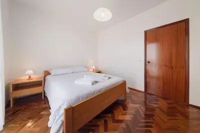 a bedroom with a bed and a wooden cabinet at Casa do Massapez by Mth in Santa Cruz