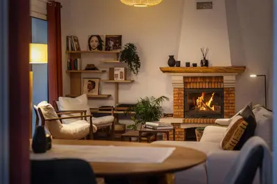 a living room with couches and a fireplace at Villa Crossdeira - A Wellness Retreat in Arco da Calheta