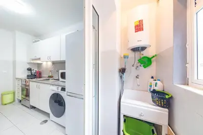 a kitchen with a washing machine and a sink at Apartamento Vieira by Mth in Campanário