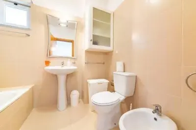 a bathroom with a white toilet and a sink at Apartamento Vieira by Mth in Campanário