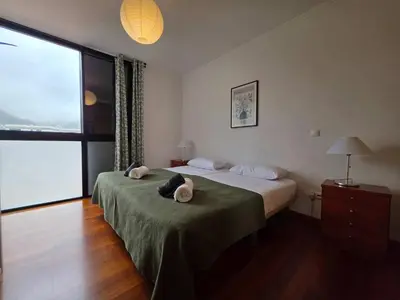 a bedroom with a bed with two towels on it at Ocean View Machico in Machico